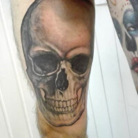 Tatouage tête de mort sur la cuisse gauche