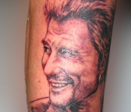 Tatouage portrait de Johnny Hallyday en noir et dégradés, style réaliste